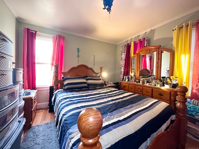 bedroom featuring crown molding and hardwood / wood-style flooring