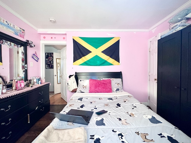 bedroom with crown molding and dark hardwood / wood-style flooring