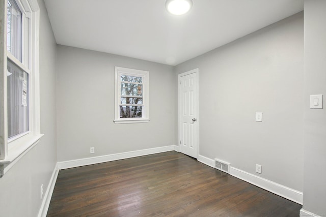 unfurnished room featuring dark wood-type flooring