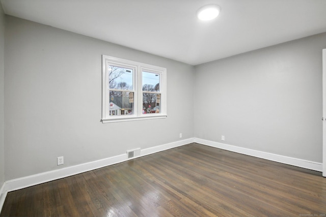 empty room featuring dark wood-type flooring