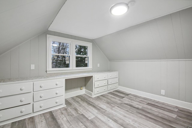 bonus room with light hardwood / wood-style floors and lofted ceiling