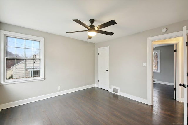 spare room featuring ceiling fan and dark hardwood / wood-style flooring