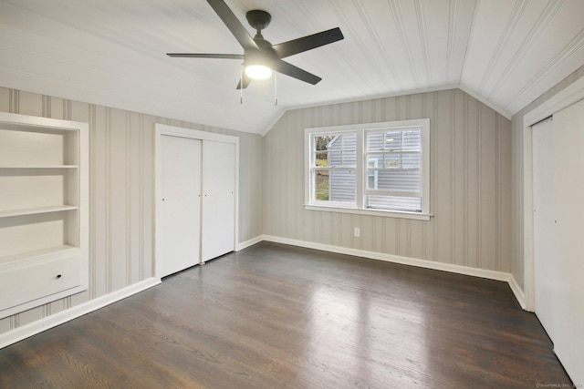 unfurnished bedroom featuring ceiling fan, a closet, dark wood-type flooring, and lofted ceiling