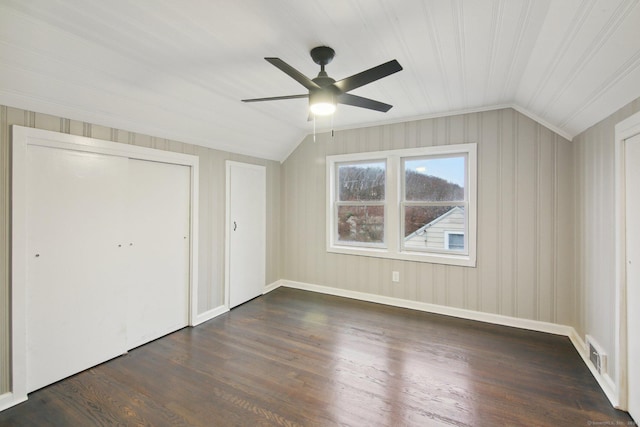 unfurnished bedroom with dark hardwood / wood-style flooring, vaulted ceiling, and ceiling fan