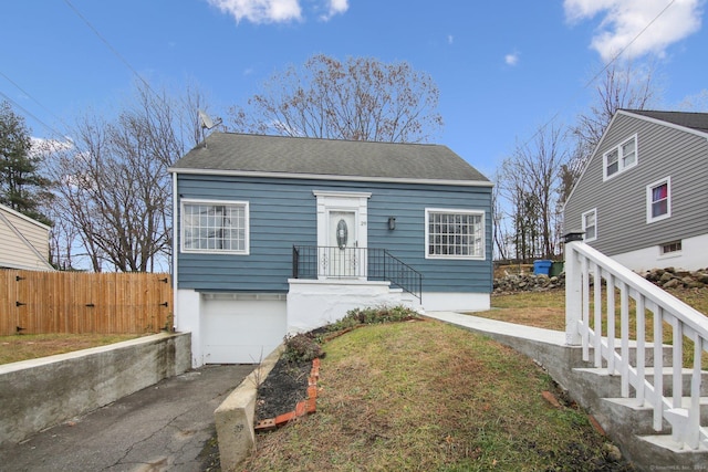 view of front of property featuring a front yard and a garage