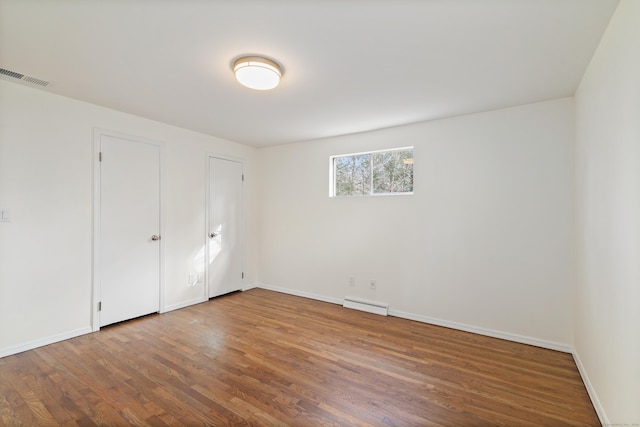 unfurnished room with hardwood / wood-style floors