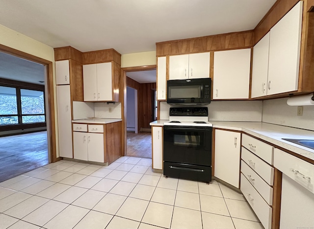 kitchen featuring light hardwood / wood-style flooring, white cabinetry, baseboard heating, and black appliances