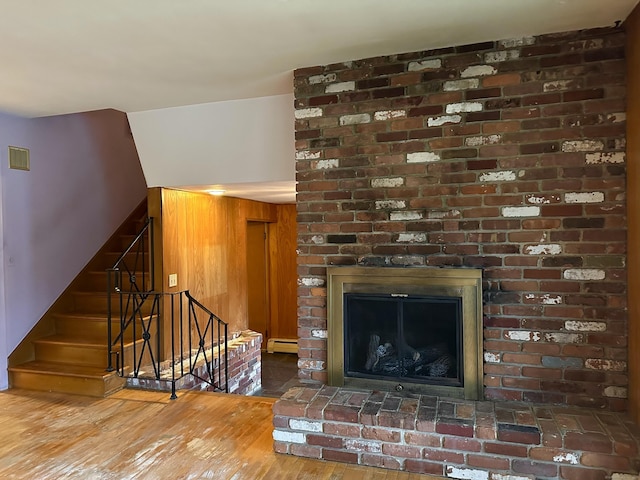 interior space with a fireplace, hardwood / wood-style floors, and a baseboard radiator