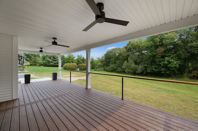 wooden terrace with ceiling fan and a yard