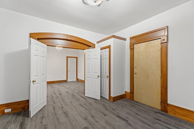 unfurnished bedroom featuring hardwood / wood-style flooring