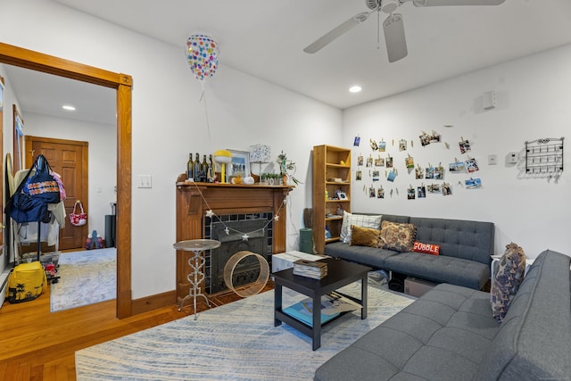 living room featuring ceiling fan and wood-type flooring