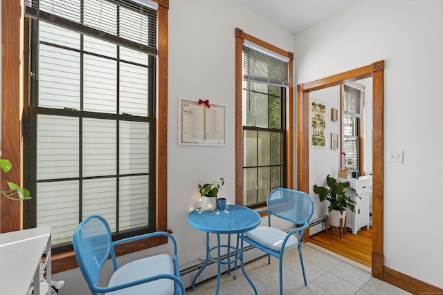 living area featuring light tile patterned floors and a baseboard radiator