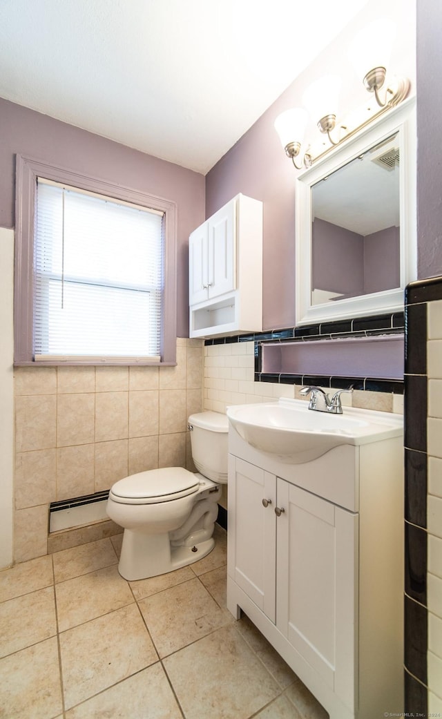 bathroom featuring vanity, a baseboard heating unit, tile walls, tile patterned flooring, and toilet