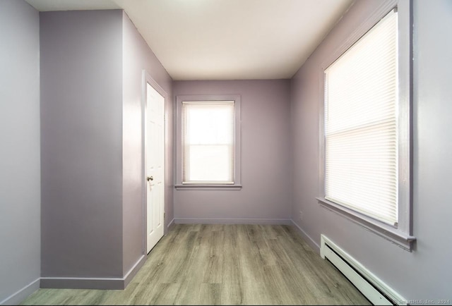 spare room with light hardwood / wood-style floors and a baseboard radiator