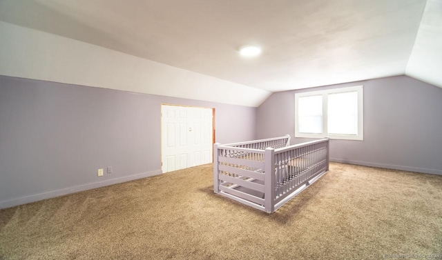 carpeted bedroom with a closet and lofted ceiling