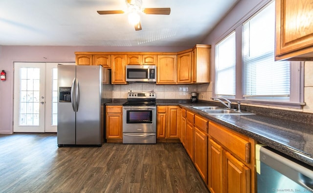 kitchen featuring backsplash, dark wood-type flooring, french doors, sink, and appliances with stainless steel finishes