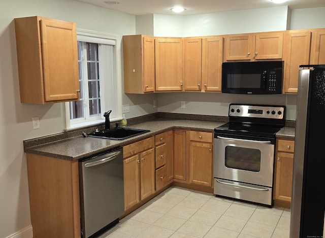 kitchen featuring sink, light tile patterned floors, and stainless steel appliances