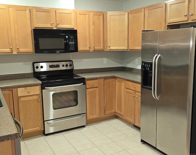 kitchen with light tile patterned floors and appliances with stainless steel finishes