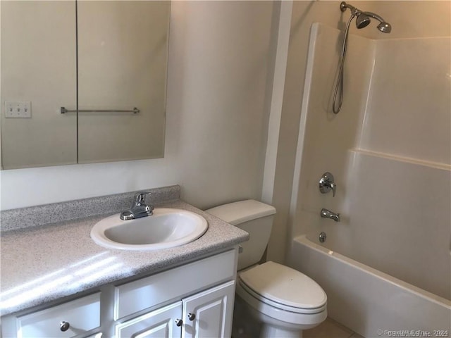 full bathroom featuring toilet, vanity, and tub / shower combination