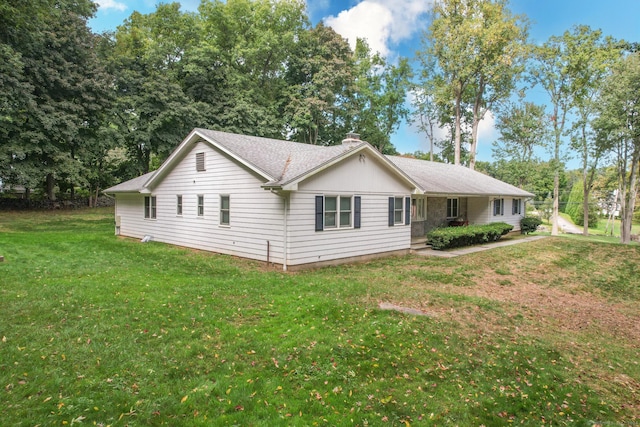 view of side of home with a lawn