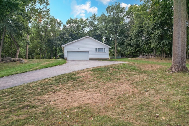 view of home's exterior featuring a lawn and a garage