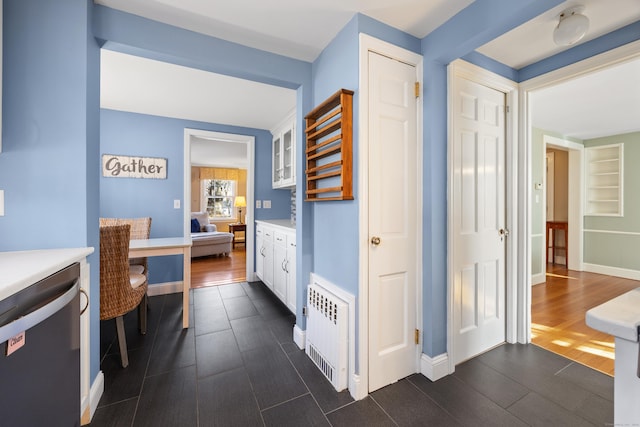 corridor with radiator and dark hardwood / wood-style floors