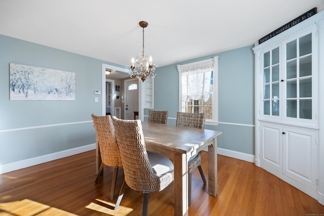 dining room with a chandelier and light hardwood / wood-style flooring