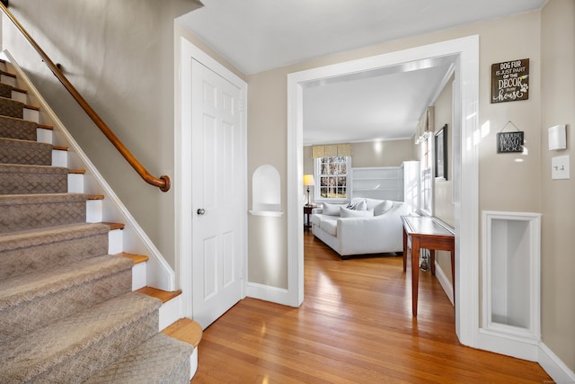 stairs featuring hardwood / wood-style floors