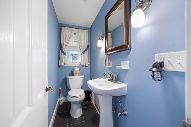 bathroom featuring sink, tile patterned flooring, and toilet