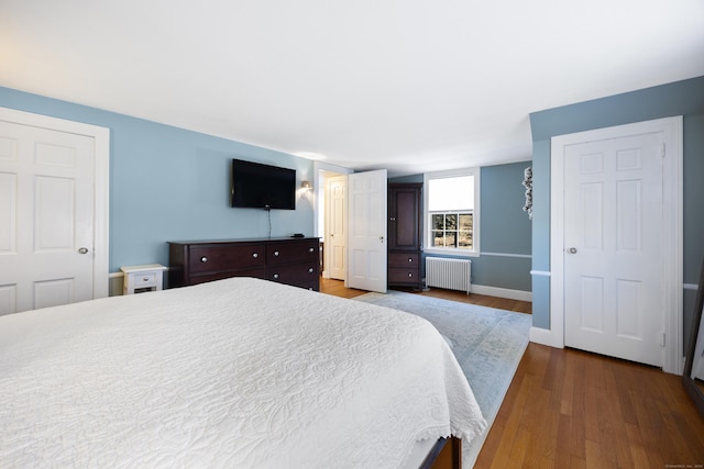 bedroom featuring hardwood / wood-style flooring and radiator