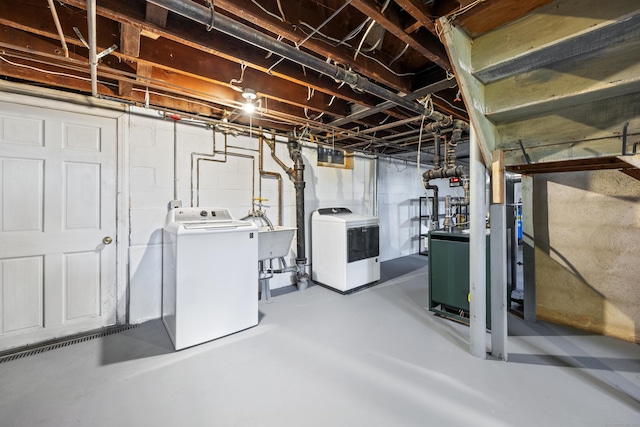 basement featuring sink and washing machine and clothes dryer