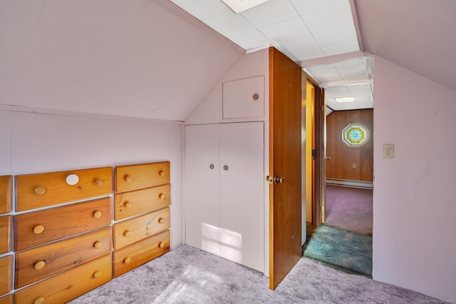 bonus room with baseboard heating, wood walls, carpet, and lofted ceiling