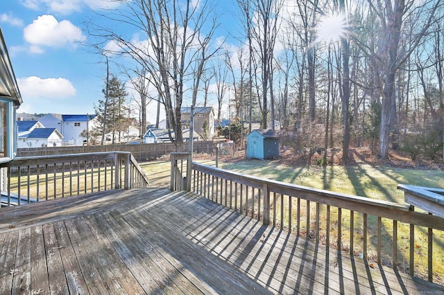 wooden deck with a yard and a storage shed