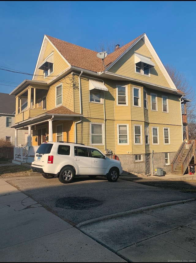 view of front of home featuring cooling unit and covered porch