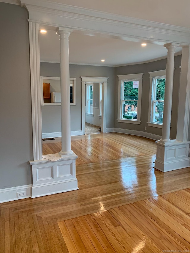 unfurnished living room featuring light hardwood / wood-style floors and ornamental molding