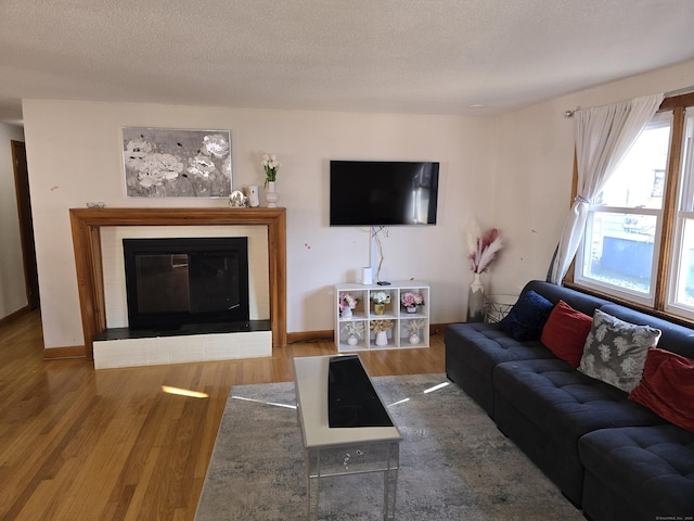 living room featuring wood-type flooring and a textured ceiling