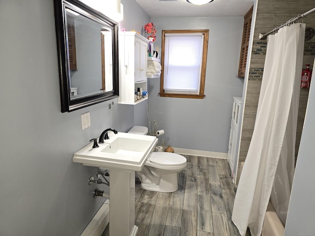 bathroom featuring hardwood / wood-style floors and toilet