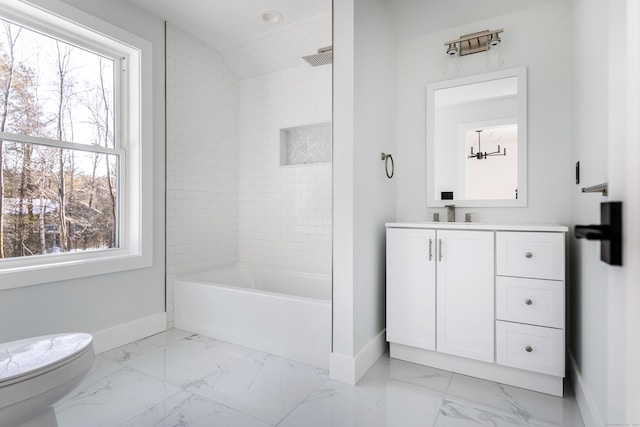 bathroom featuring baseboards, toilet,  shower combination, marble finish floor, and vanity