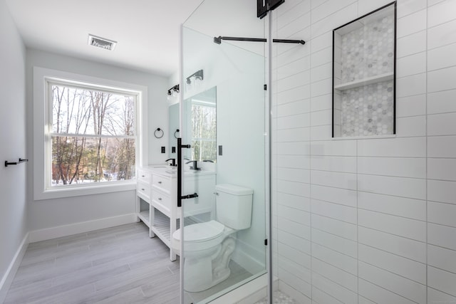 68 Paxton Ct, Goshen, CT 06756 - bathroom with vanity, toilet, tiled shower, and baseboards