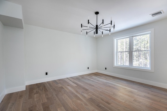 68 Paxton Ct, Goshen, CT 06756 - unfurnished room with a chandelier, light wood-style flooring, and baseboards