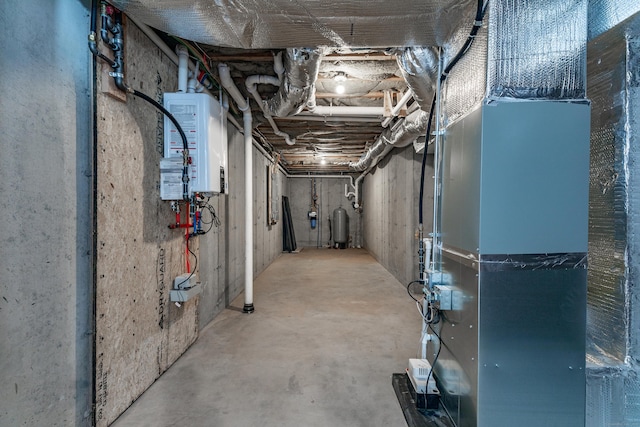 unfinished basement with water heater and heating unit