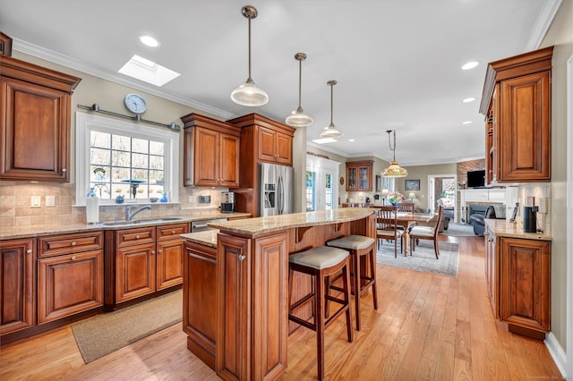 23 Olmstead Rd, East Haddam, CT 06423 - kitchen with stainless steel appliances, a sink, a skylight, a kitchen island, and light wood-type flooring