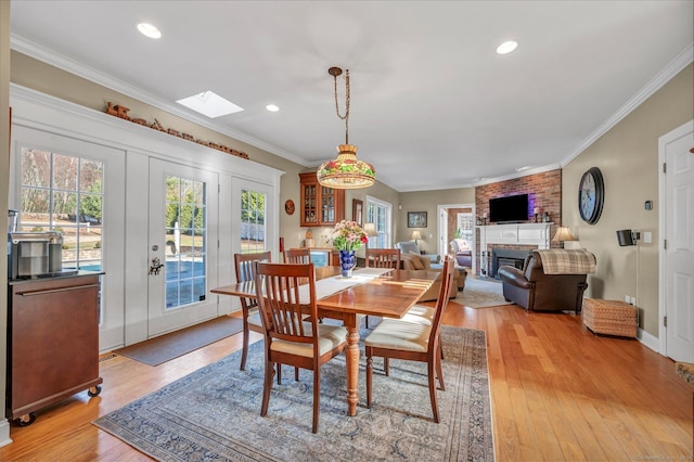 23 Olmstead Rd, East Haddam, CT 06423 - dining room with a brick fireplace, a skylight, ornamental molding, light wood finished floors, and recessed lighting