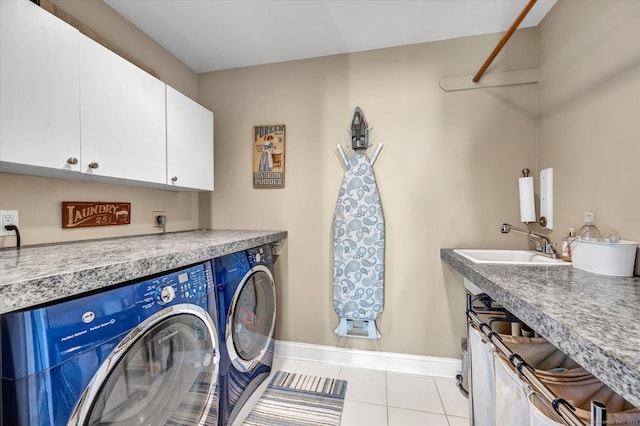 washroom with cabinets, sink, separate washer and dryer, and light tile patterned flooring