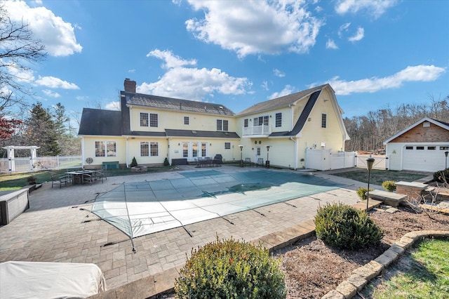 view of pool with an outbuilding and a patio