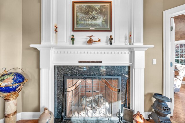 interior details with a fireplace and wood-type flooring