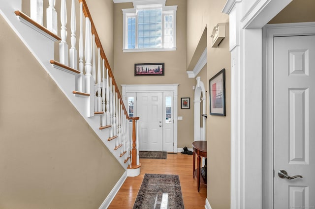 23 Olmstead Rd, East Haddam, CT 06423 - entrance foyer featuring light wood finished floors, baseboards, a towering ceiling, and stairs
