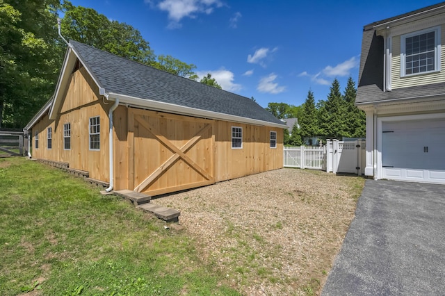 23 Olmstead Rd, East Haddam, CT 06423 - view of property exterior with a garage, a shingled roof, an outdoor structure, a gate, and driveway