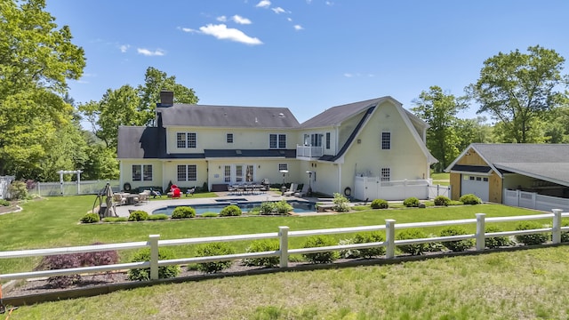 23 Olmstead Rd, East Haddam, CT 06423 - back of property with stucco siding, a chimney, a garage, and a balcony