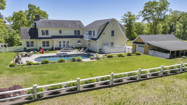 23 Olmstead Rd, East Haddam, CT 06423 - back of property featuring a fenced backyard, a garage, a chimney, and a pool with connected hot tub